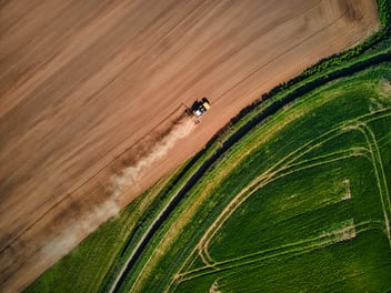 Photo of tractor driving through field